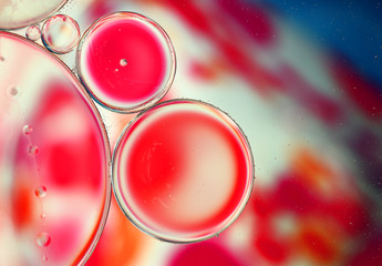 Oil drops on a water surface, abstract macro background.