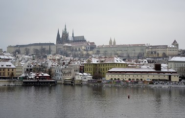 Prague castle with snow and grey sky