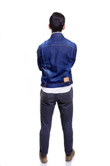 Young casual man standing from back with arms crossed, isolated