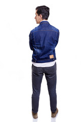 Fototapeta premium Young casual man standing from back with arms crossed, isolated