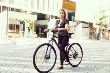 Fototapeta na wymiar Young woman commuting on bicycle