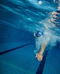 Young man swimming in pool