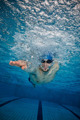 Young man swimming in pool