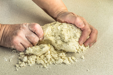 Kneading of dough with hands.