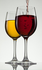 Glass of wine and bottle on white with copy space