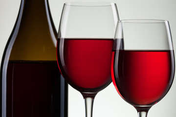 Glass of wine and bottle on white with copy space