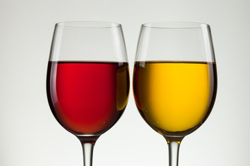 Glass of wine and bottle on white with copy space