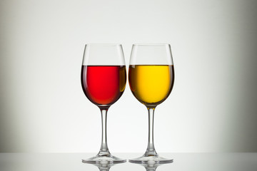 Glass of wine and bottle on white with copy space