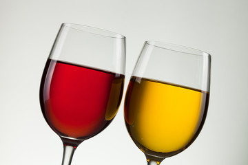 Glass of wine and bottle on white with copy space