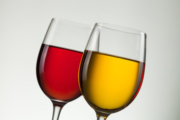 Glass of wine and bottle on white with copy space