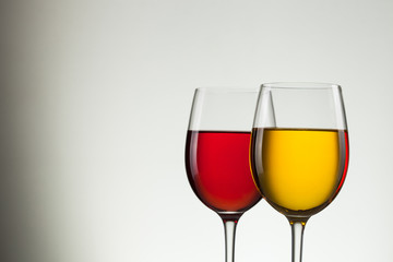 Glass of wine and bottle on white with copy space