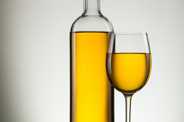 Glass of wine and bottle on white with copy space