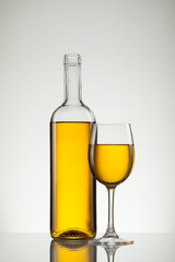 Glass of wine and bottle on white with copy space