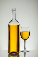Glass of wine and bottle on white with copy space