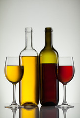 Glass of wine and bottle on white with copy space