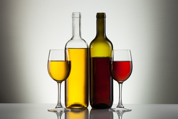 Glass of wine and bottle on white with copy space