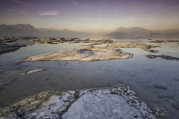 Long exposure during the warm light of an incredible sunset on the Garda lake in Sirmione