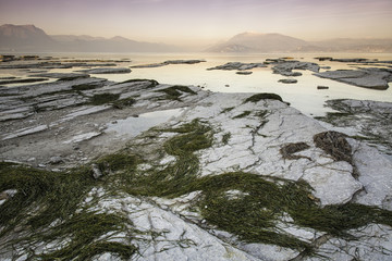 Long exposure during the warm light of an incredible sunset on the Garda lake in Sirmione