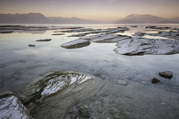 Long exposure during the warm light of an incredible sunset on the Garda lake in Sirmione