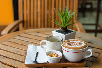 Hot Coffee in white cup on wooden table