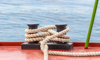 Mooring bollard with a fixed rope on the ship