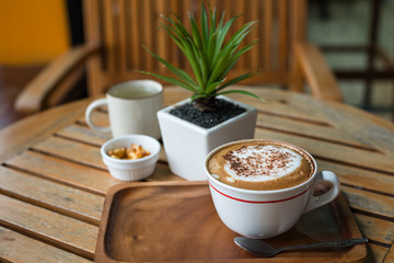 Hot Coffee in white cup on wooden table