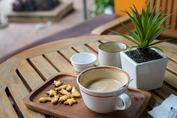 Hot Coffee in white cup on wooden table