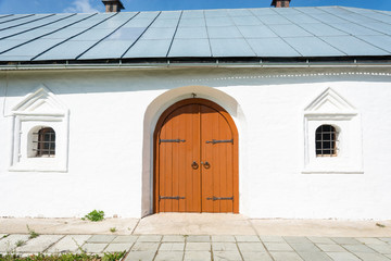 Old wooden orange door in the monastery Church.