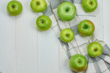 Ripe green apples on light wooden background. Nature fruit concept. Top view. Close-up. Selective focus.
