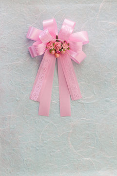 Pink bow on blue mulberry paper