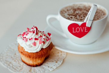 Beautiful coffee Cup with heart cupcake on white wooden background