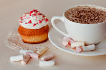Beautiful coffee Cup with heart cupcake on white wooden background