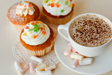Beautiful coffee Cup with heart cupcake on white wooden background