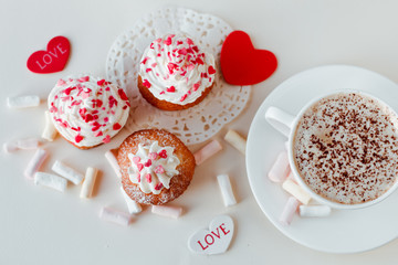 Beautiful coffee Cup with heart cupcake on white wooden background