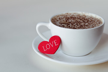 Beautiful coffee Cup with heart on a white wooden background