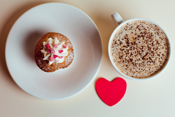 Beautiful coffee Cup with heart cupcake on white wooden background