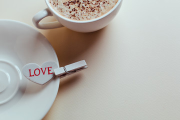 Beautiful coffee Cup with heart cupcake on white wooden background