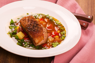 Spanish hot vegetable soup with duck breast. Rustic style. Toned image. Top view