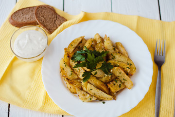 beautiful roasted potatoes with herbs and spices on a white plate