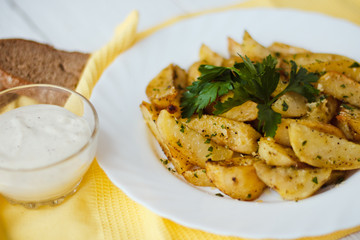beautiful roasted potatoes with herbs and spices on a white plate