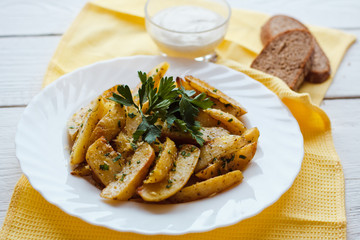beautiful roasted potatoes with herbs and spices on a white plate