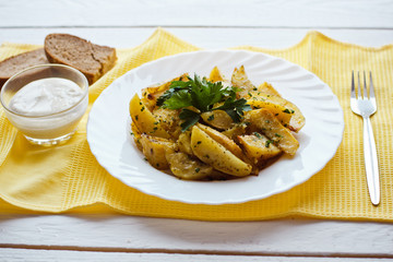 beautiful roasted potatoes with herbs and spices on a white plate
