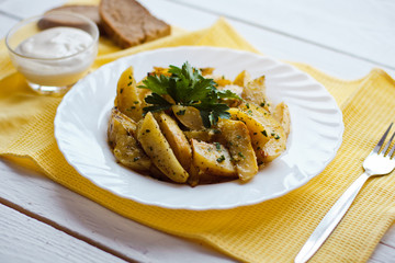 beautiful roasted potatoes with herbs and spices on a white plate