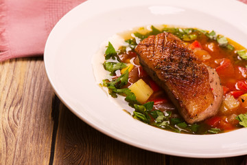Spanish hot vegetable soup with duck breast. Rustic style. Toned image. Top view