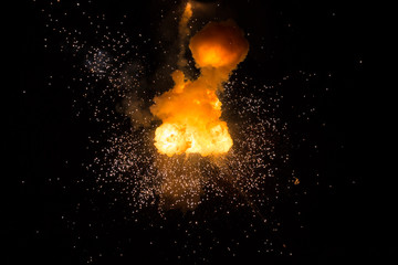 Realistic fiery explosion busting over a black background
