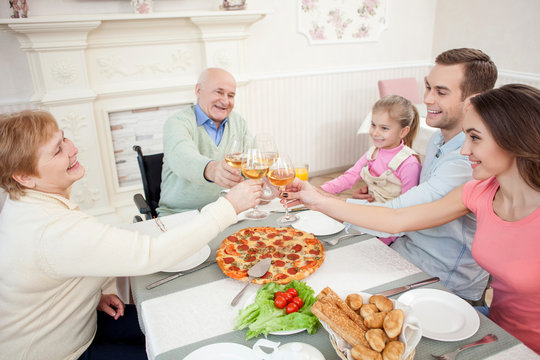 Cheerful grandparents are celebrating event with children