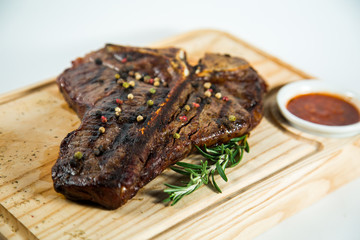 Beautiful juicy well done steak with sauce on a wooden Board