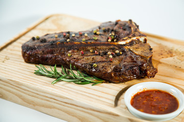 Beautiful juicy well done steak with sauce on a wooden Board