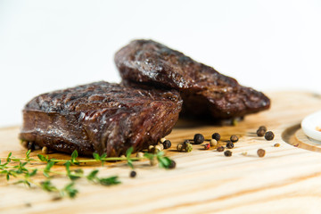 Beautiful juicy well done steak with sauce on a wooden Board