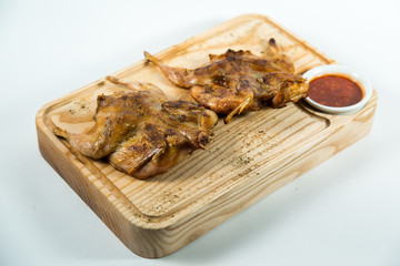Beautiful juicy chicken grilled with sauce on a wooden Board